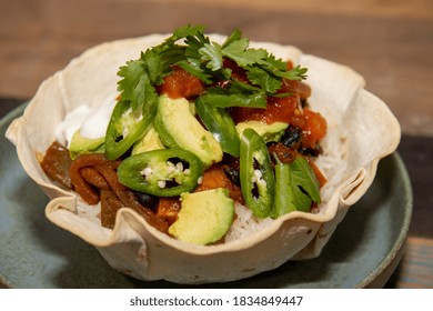 A Delicious Black Bean Burrito Bowl On A Wooden Kitchen Work Top