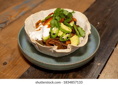 A Delicious Black Bean Burrito Bowl On A Wooden Kitchen Work Top