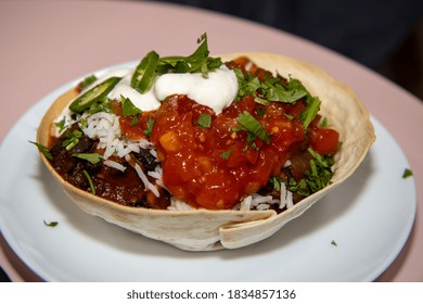 A Delicious Black Bean Burrito Bowl On A Pink  Wooden Kitchen Work Top