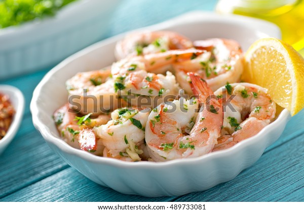 A delicious bowl of shrimp scampi with garlic,\
butter, and parsley.