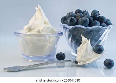 Delicious bowls of ripe blueberries and whipped cream - Powered by Shutterstock