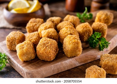 Delicious Breaded Fish Nugget Snacks On A Rustic Wood Table Top.