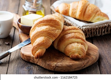 Delicious breakfast with fresh croissants and coffee served with butter and honey. - Powered by Shutterstock