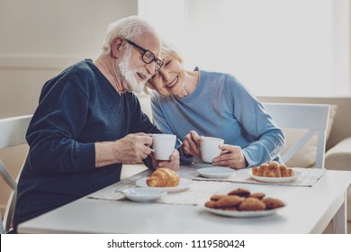 Delicious breakfast. Happy joyful couple smiling while having a meal together - Powered by Shutterstock