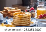 Delicious Breakfast Spread with Pancakes, Syrup, and Fresh Fruit