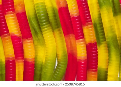 Delicious bright jelly candies worms. Background made of gummy worms for halloween holiday or food concept.