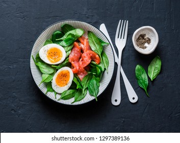 Delicious Brunch - Spinach, Smoked Salmon, Soft Boiled Egg On A Dark Background, Top View. Healthy Eating Diet Concept 