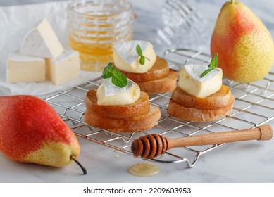 Delicious Bruschetta With Caramelized Pear, Camembert Or Brie Cheese, Honey And Mint. Fruit Dessert. Bread Toast, Crostini. Healthy Breakfast For Gourmets. Selective Focus, Copy Space