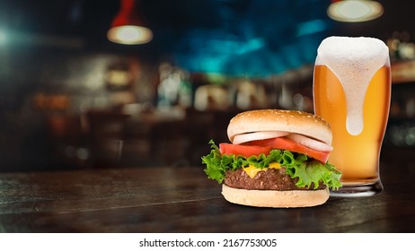Delicious Burger With Beer Closeup View, Presented On The Generic Blurred Restaurant Background.