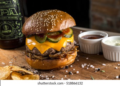 Delicious Burger With Cheddar Cheese And Cucumber Relish On A Rustic Wooden Table