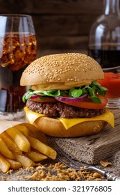 Delicious Burger With Chips And Soda On Wooden Table