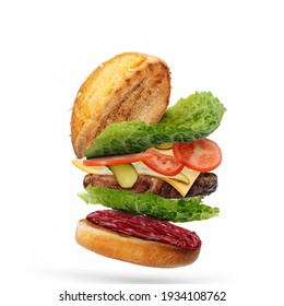 Delicious burger with flying ingredients isolated on white