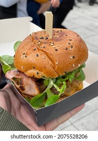 Delicious Burger In A Sesame Bun Garnished With Cornmeal And Crispy Bacon