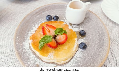 Delicious Buttermilk Pancake With Fresh Berries And Maple Syrup In Small Jug. Tasty Sweet Food On Breakfast In Hotel Or Cafe. Dessert With Strawberry And Blueberry.