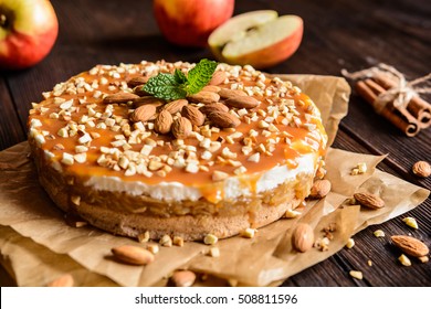 Delicious cake with apple and whipped cream filling, topped with caramel and almond