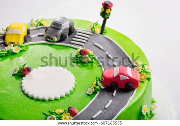 Delicious cake with ladybugs, cars and traffic\
light with free place for text close\
up.