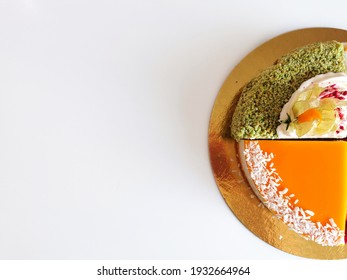 Delicious Cake On White Background. Cheesecake With Mango, Green Velvet. Holiday Baked Goods. Place For Text