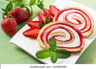 Delicious Cake Roll With Strawberry Marmalade And Marshmallow. Sliced Rolls On A Plate, Fresh Strawberry And Mint. Tasty Fruit Dessert