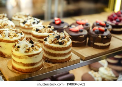 Delicious Cake With White Vanilla Butter Cream, Nuts.Sweet Chocolate Dessert With Berries On Display In A Cafe.Handmade Homemade Cakes.A Pastry Shop With Cakes.