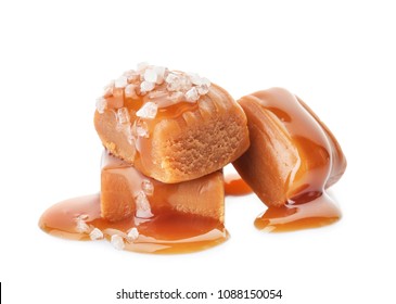 Delicious candies with caramel sauce and salt on white background - Shutterstock ID 1088150054