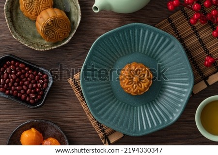 Delicious Cantonese moon cake for Mid-Autumn Festival food mooncake on wooden table background for afternoon tea, holiday celebration serving.