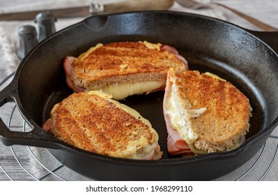 Delicious cast iron pan fried ham and cheese sandwich made with german sourdough bread served on wooden rustic table - Powered by Shutterstock