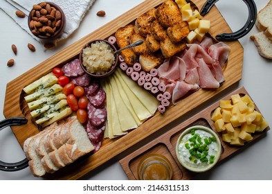 Delicious Charcuterie Board With Snacks Cheese, Toast, Ham, Blue Cheese, Almonds, Caramelized Onions, Green Onion, Honey, Toast. Flat-lay View. Family, Friends Holiday Gathering.