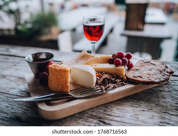 Delicious cheese plate, various cheeses with red port at a beach club