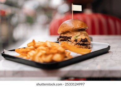 Delicious cheeseburger served with crispy fries. Perfect meal for a casual dining experience. - Powered by Shutterstock