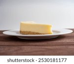 delicious cheesecake on a white plate. Wooden background, front view