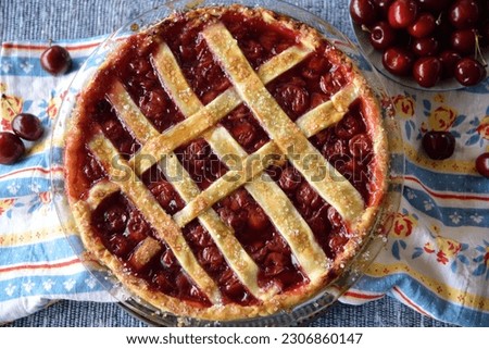 Delicious cherry pie with fresh cherries and on a blue background