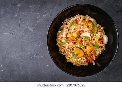 delicious chinese fried noodles on a black background. - Shutterstock ID 2207076325