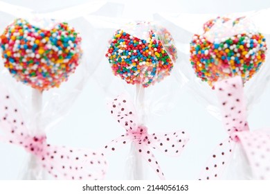 Delicious chocolate cake pop and icing dipped in a milk chocolaty coating and covered with multi-colored sprinkles. - Powered by Shutterstock