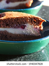 Delicious Chocolate Cake With Quark Sour Cream And Blackberry Filling, Slice Of Cake Served On A Green Plate, Closeup