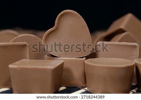 Delicious chocolate candy of different forms, including heart-shaped ones. Chocolate candies. Valentines Day Gift