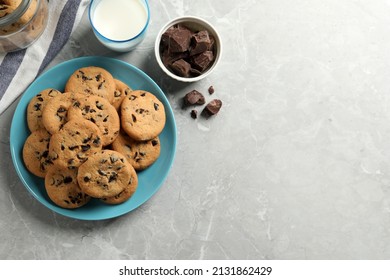 Delicious chocolate chip cookies and glass of milk on grey marble table, flat lay. Space for text - Powered by Shutterstock