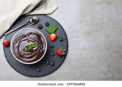 Delicious chocolate cream with berries and mint on grey table, top view. Space for text - Powered by Shutterstock