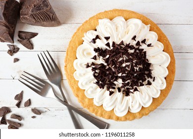 Delicious Chocolate Cream Pie. Top View Table Scene On A White Wood Background.