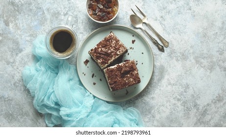 Delicious Chocolate Layered Cake Served On Plate With Black Cofee On Table On Light Background