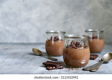 Delicious chocolate mousse in a vintage glasse jar on a light grey slate, stone or concrete background. - Powered by Shutterstock