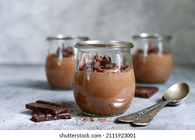 Delicious chocolate mousse in a vintage glasse jar on a light grey slate, stone or concrete background. - Shutterstock ID 2111923001