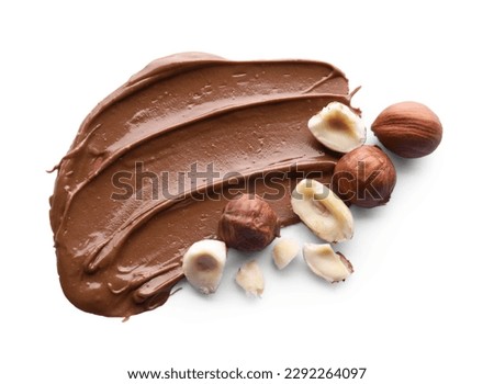 Delicious chocolate paste with hazelnuts on white background, top view
