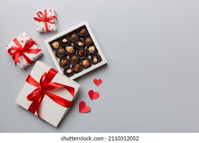 Delicious Chocolate Pralines In Red Box For Valentine's Day. Heart Shaped Box Of Chocolates Top View With Copy Space.