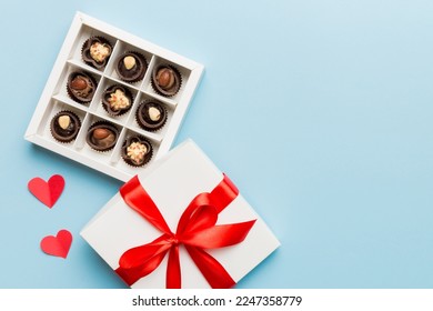 Delicious chocolate pralines in red box for Valentine's Day. Heart shaped box of chocolates top view with copy space. - Shutterstock ID 2247358779