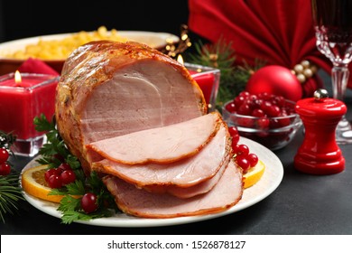 Delicious Christmas Ham Served With Garnish On Dark Table