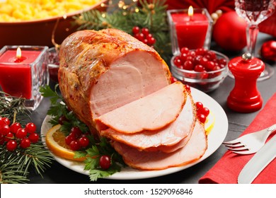 Delicious Christmas Ham Served With Garnish On Dark Table