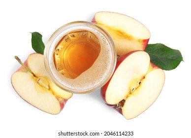 Delicious cider in glass near pieces of ripe apple on white background, top view