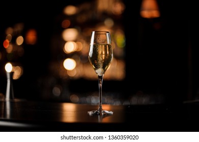 Delicious Cocktail With Champagne And A Sugar Cube In The Glass On The Bar Counter In The Dark Blurred Background