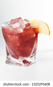 Delicious Cocktail Using Hydrated Chia Seeds And Tart Cherry Juice With Fresh Lemon Served On The Rocks Over A White Background