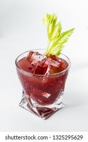 Delicious Cocktail Using Hydrated Chia Seeds And Tart Cherry Juice With Fresh Celery Served On The Rocks Over A White Background